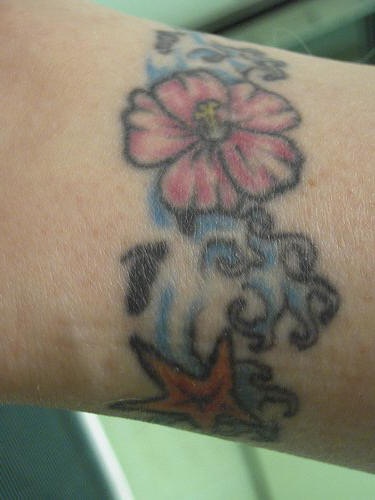 Hibiscus in sea armband tattoo