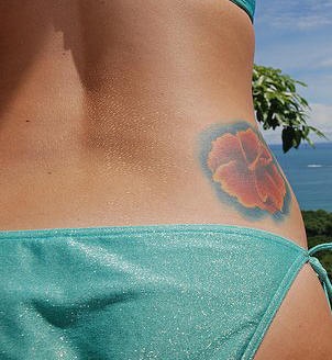 Hibiscus flower on side tattoo
