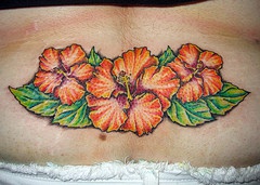 Hibiscus flower tattoo on lower back