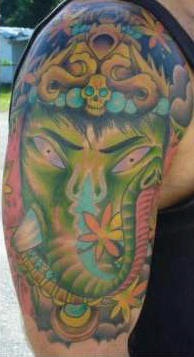 Green angry ganesha shoulder tattoo