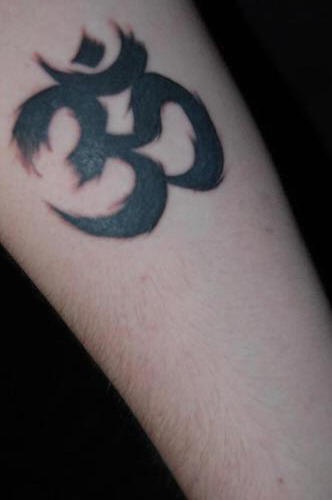 Black ink om symbol tattoo