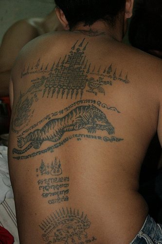 Tibetian writings and tiger full back tattoo