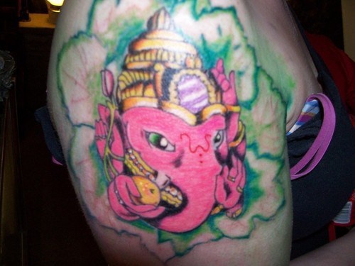 Pink ganesha in green lotus tattoo
