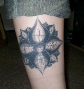Black ink lotus leg tattoo