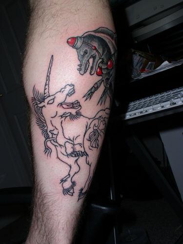 Unicorn fighting dolphin tattoo