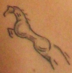 Minimalistic small horse tattoo