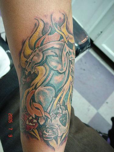 Metallic horse in flame tattoo