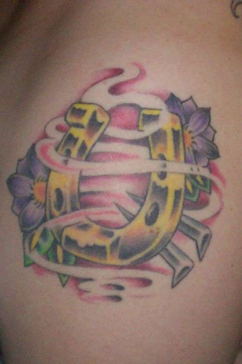 Golden horseshoe with flowers tattoo