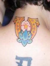 Golden horseshoe and blue lotus tattoo