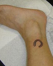 Horseshoe tattoo on leg