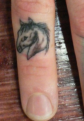 Small horse head tattoo on finger