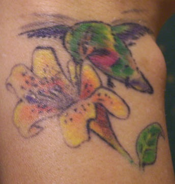 Detailed hummingbird and flower tattoo