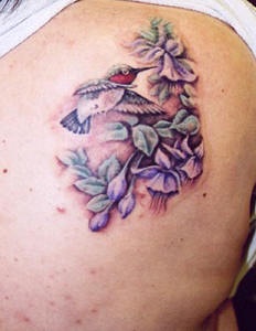 tatuaje de colibrí bonito en violetas