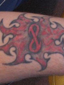 Tatuaje rojo-negro del símbolo del infinito en fuego