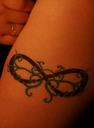 Infinity symbol with tracery tattoo