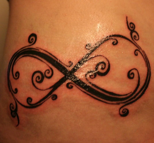 Infinity symbol tracery hip tattoo