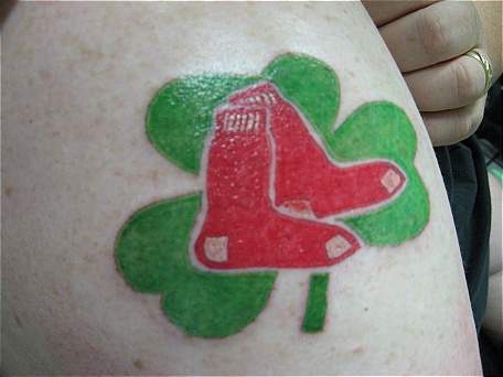 Green shamrock and red socks tattoo