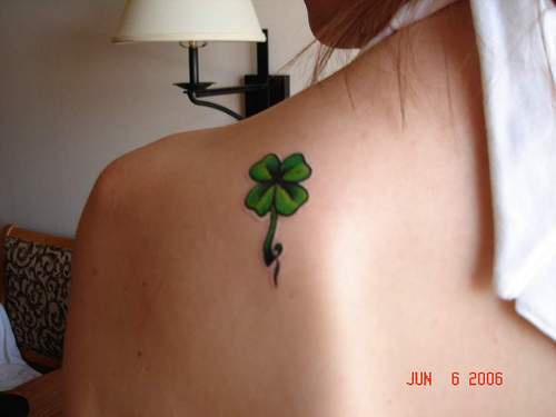 Green four leaf clover tattoo on shoulder