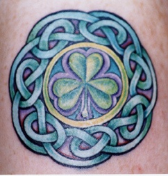 Green clover in celtic tracery tattoo