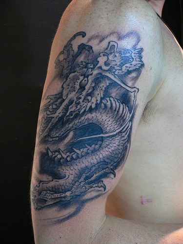 Black asian dragon in flight tattoo