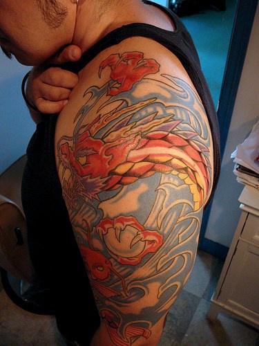 Red asian dragon with magic sphere tattoo