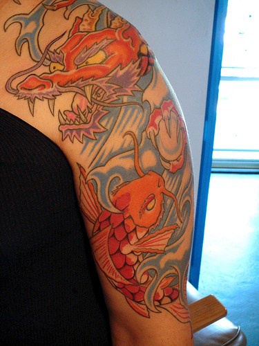 Japanese koi and dragon in sea tattoo