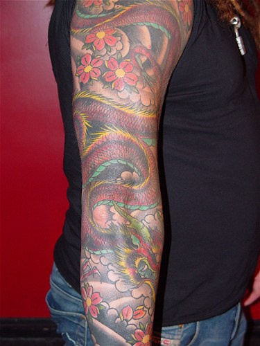 Japanese demon and flowers full sleeve tattoo