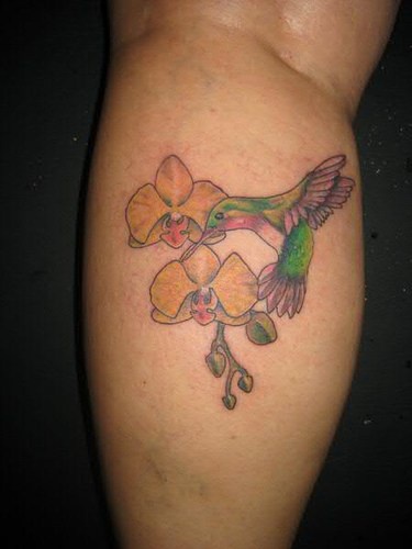 Yellow orchid and hummingbird tattoo