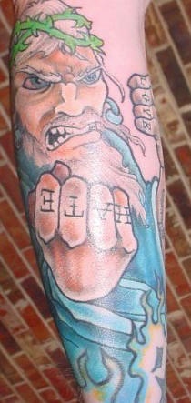 Angry jesus with letterings on  knuckles tattoo