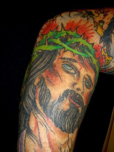 Colourful jesus pain traditional tattoo