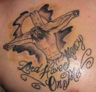 Jesus on cross with writings tattoo
