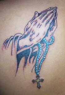 Praying hands with blue rosary tattoo