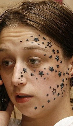 Tattoo von Sternchen auf dem Gesicht