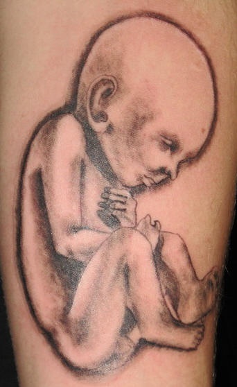 Newborn child black ink tattoo