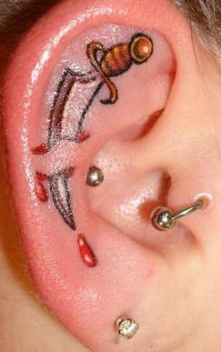 Little knife in blood tattoo in ear