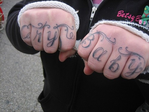 Knuckle tattoo, cry baby, curled styled  inscription