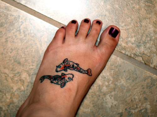 Small koi fishes tattoo on foot