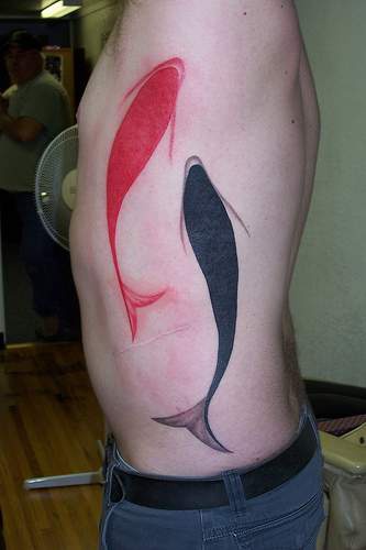 Minimalistic black and red koi fish tattoo