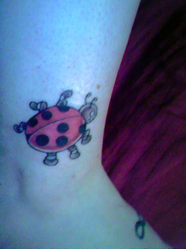 Cartoonish ladybug  tattoo on ankle