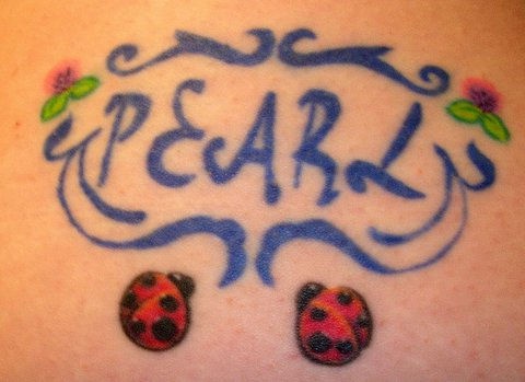 Pearl writing with ladybugs tattoo