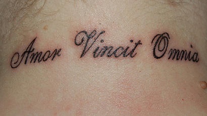 Amor vincit omnia lettering tattoo