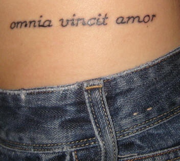 Love conquers all in latin tattoo