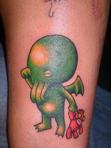 Leg band tattoo,creature monster child crying with toy