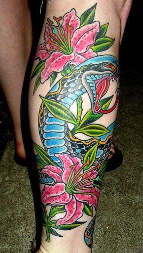 Leg sleeve tattoo, blue, colourful snake in bright pink lillies