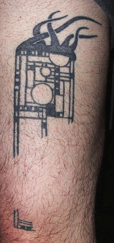Leg tattoo, black square designed image with circles and curls