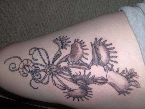 Leg tattoo, tall strange plant with worms