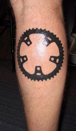 Leg tattoo, mechanic detail, black ring, chain