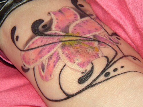 Lily flower with black tracery tattoo