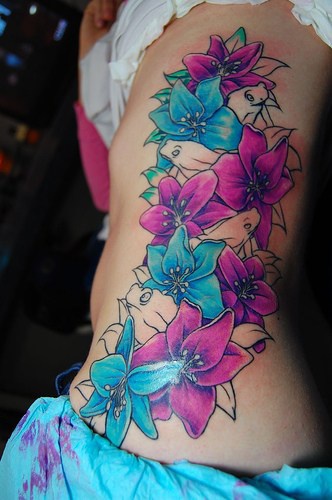 Blue and purple lilies tattoo on side