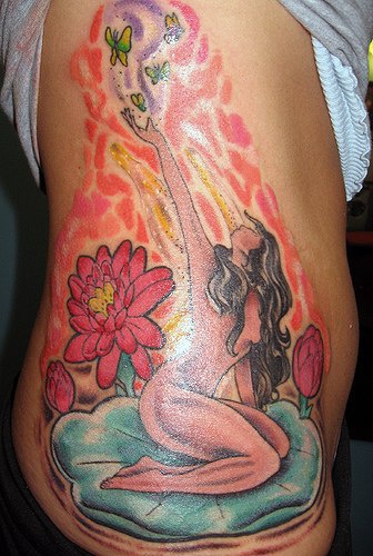 Naked girl on blue water lily tattoo